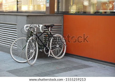 Cozy city picture, bicycles parked near the building, orange wall. Seoul, South Korea