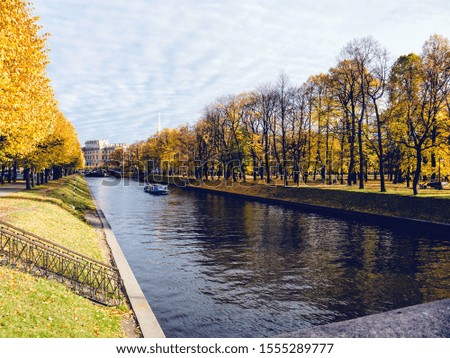 Walk on a pleasure boat on the Moika River in the background of the Engineering Castle. Autumn. Russia, Saint-Petersburg