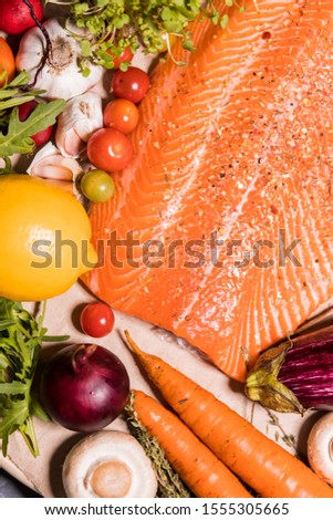 Closeup beautiful fresh salmon fillet with seasonings, herbs and vegetables on the table. Healthy food, restaurant, Haute cuisine, , diet concept. top view.