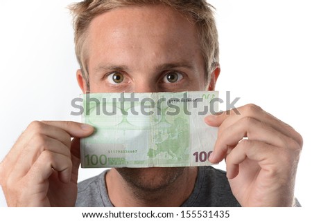 close up of caucasian man holding a Ã?Â??100 euro banknote and peering over it on a white background