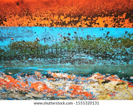 closeup of waterline orange blue grunge patterns on painted hull of fishing boat