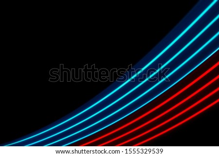 Red and blue light dynamics lines on a black background 	
