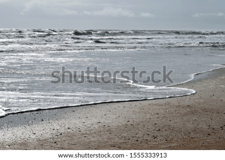 Ocean waves breaking at the beach surf background.