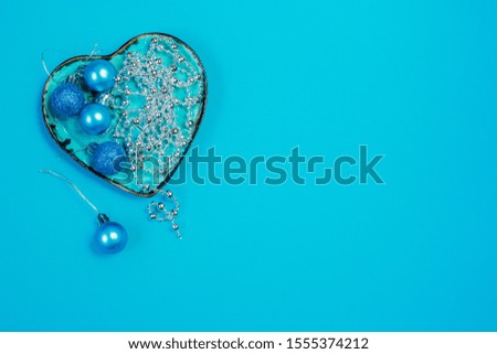 Colorful blue christmas decoration baubles and hart on blue backgraund with space for text