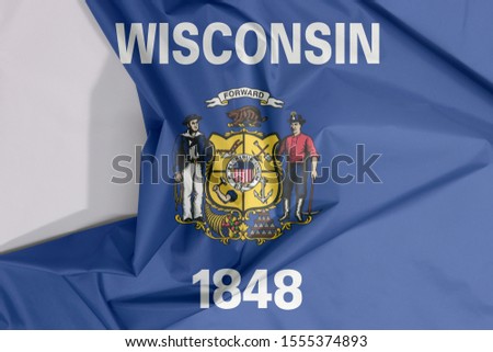 Wisconsin fabric flag crepe and crease with white space, the states of America. Coat of arms on dark blue field with the name of the state and the date 1848.