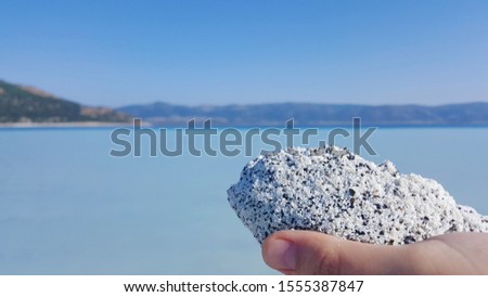 View of salda lake Burdur, Turkey, called as Maldives. Close up on white sandstone on a hand