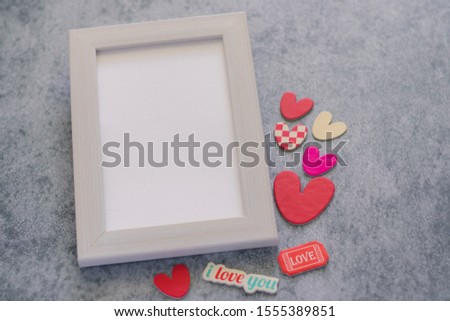 Beautiful cute white pastel frame with lovely hearts on black background. Photo for couple and lover or family and friends. Romantic Valentine conceptual image. Love is all around concept.