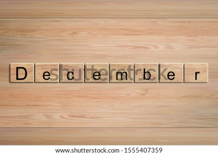 December word written on wood block. Message text on wooden table for backdrop design.