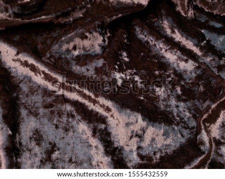 velvet clothes in dark brown colors texture 