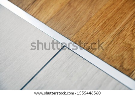aluminum threshold between ceramic tiles and parquet	