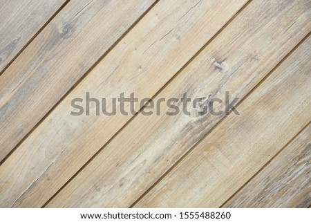 Closeup of old stained wooden panel wall with grain knot and rough texture in brown tone for background and decoration