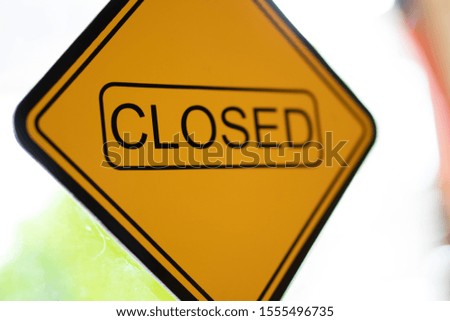 The yellow sign for closed