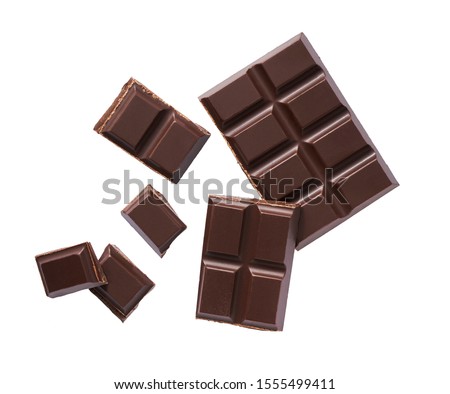 Dark chocolate pieces isolated on white background, flat lay Royalty-Free Stock Photo #1555499411