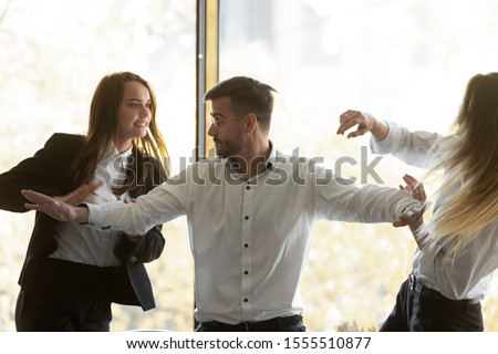Male employee set apart angry female colleagues fight quarrel at office meeting, furious angry woman coworkers dispute shout having conflict or controversy at meeting, competition, rivalry concept Royalty-Free Stock Photo #1555510877