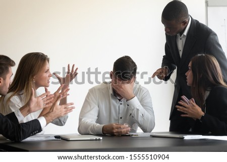 Stressed businessman feel annoyed tired with diverse loud bothering clients talking, distressed unhappy male ceo director lose patience temper avoid ignore noisy employees, work stress concept Royalty-Free Stock Photo #1555510904