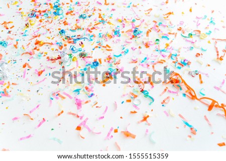 Colorful party poppers on the white floor. Abstract background. Holidays backdrop.
