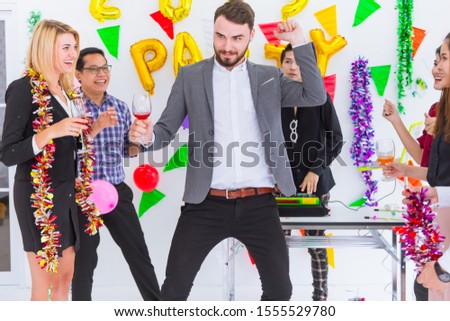 Boss dancing with staff in meeting greeting new year party in business office.