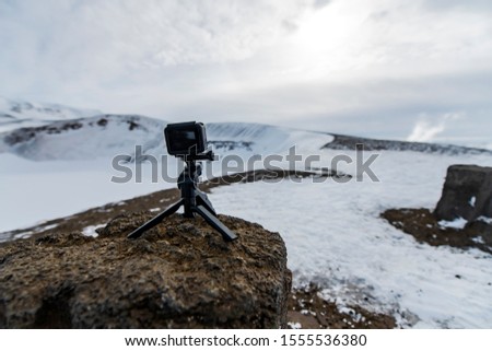 Beautiful winter landscape shot of snow covered mountains with a camera on tripod recording the scenic view in Iceland