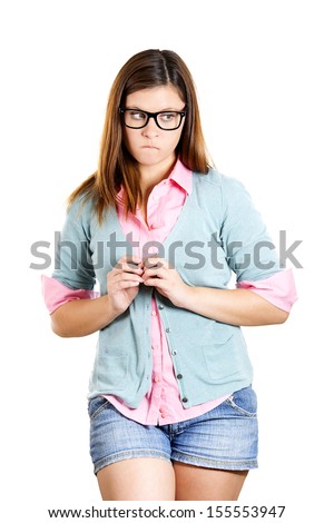 Closeup portrait of a nerdy insecure young girl with glasses, nervous looking to the side with a craving for something or anxious, isolated on white background. Human emotions, facial expressions.