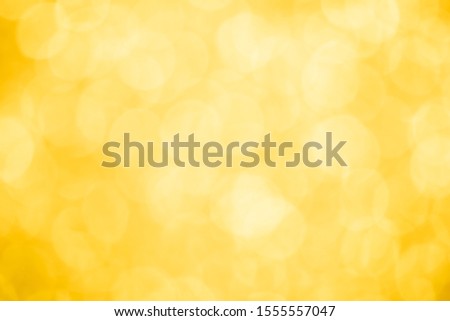 abstract blur or defocused lights bokeh on yellow background