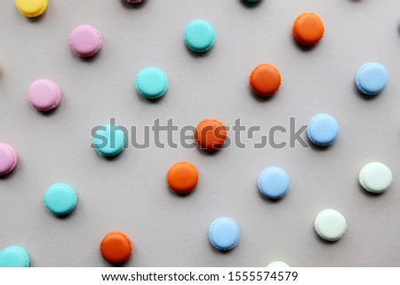 Colorful natural macarons cake, top view flat lay, sweet macaroon on gray background. Minimal concepts macaroons pattern above, food background