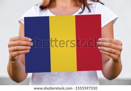  holds flag of Chad on paper sheet