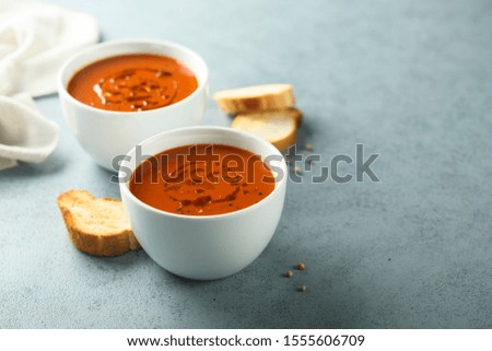 Homemade tomato soup with baguette bread