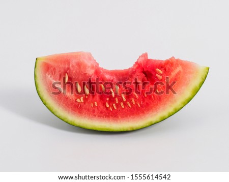 Bitten slice of watermelon on white background.