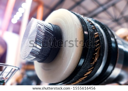 The high-voltage cable with insulated section Royalty-Free Stock Photo #1555616456