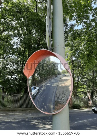 A traffic mirror mounted on the parking entrance to improve safety