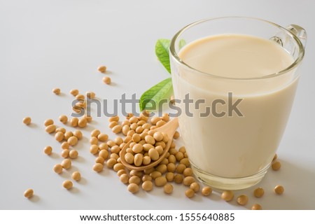 Soy milk and soy bean it on white table background,healthy concept. Benefits of Soy. protein drinking.