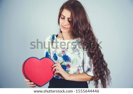 woman hand red heart on gray background