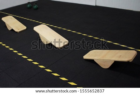 Balance boards in line on the training center floor.
