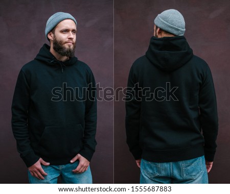 City portrait of handsome hipster man with beard wearing black blank hoodie or sweatshirt with space for your logo or design. Front and back view mockup of black hoodie