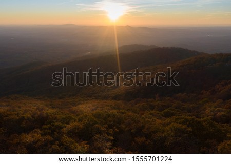Aerial view of sunset with sun rays in Jasper during the fall
