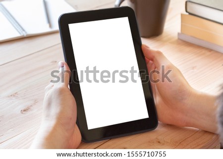 man hand using tablet computer with blank screen on workplace