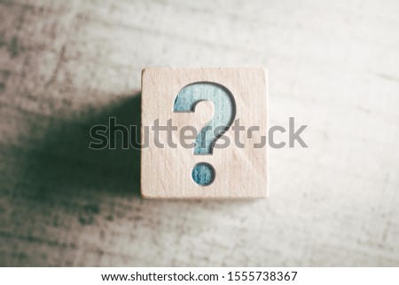 Question Mark On A Wooden Block On A Table Royalty-Free Stock Photo #1555738367
