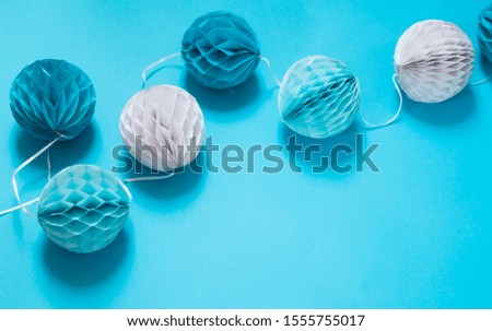 Holiday paper ornaments on blue background