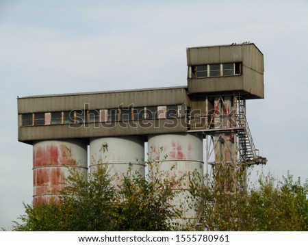 
Old abandoned factory within the autumn landscape					