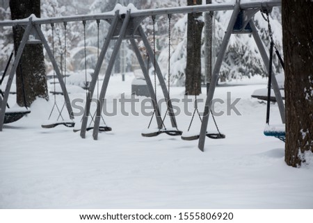 playground equipment in a snow covered park