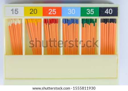 gutta-percha pins in a set of different sizes for root canal filling, material for endodontic filling, isolated, selective focus Royalty-Free Stock Photo #1555811930