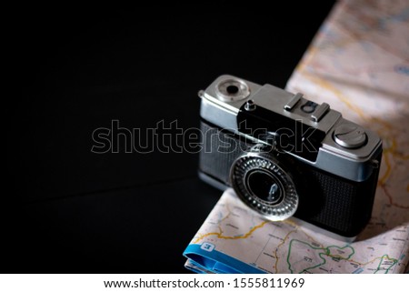 Travel Photography. Vacation trip with map. Travel planning with copy space and black background. Modern travel concept.