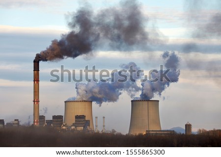 Power plant emitin smoke and steam Royalty-Free Stock Photo #1555865300