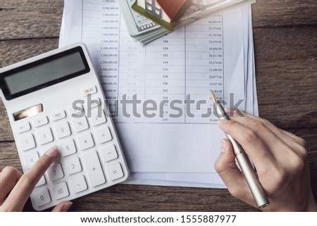 Customers use pens and calculators to calculate home purchase loans according to loan documents received from the bank. real estate concept.