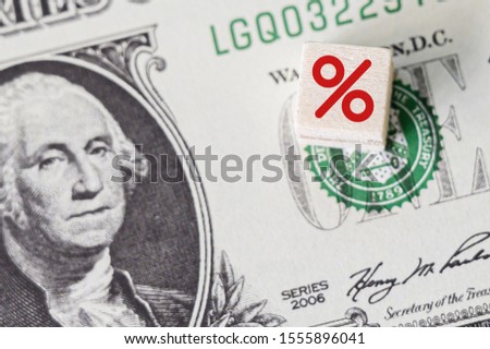 Concept idea of FED, federal reserve system is the central banking system of the united states of america and change interest rates. Percentage icon symbol on wooden cube