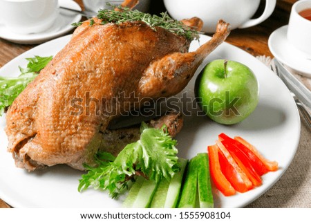 

Grill lies on a large plate with apples and vegetables