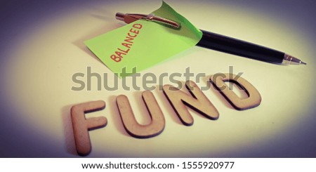 balanced fund financial terminology displayed on paper pen background 