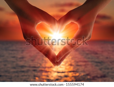 sunset in heart hands Royalty-Free Stock Photo #155594174