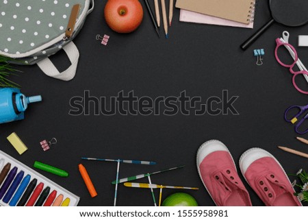 Top view mockup of Education's accessories with backpack, student books, shoes, colorful crayon, eye glasses, empty space on blackboard background, Concept of education and back to school