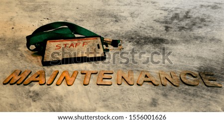 maintenance staff concept displaying with black rough paper abstract background 